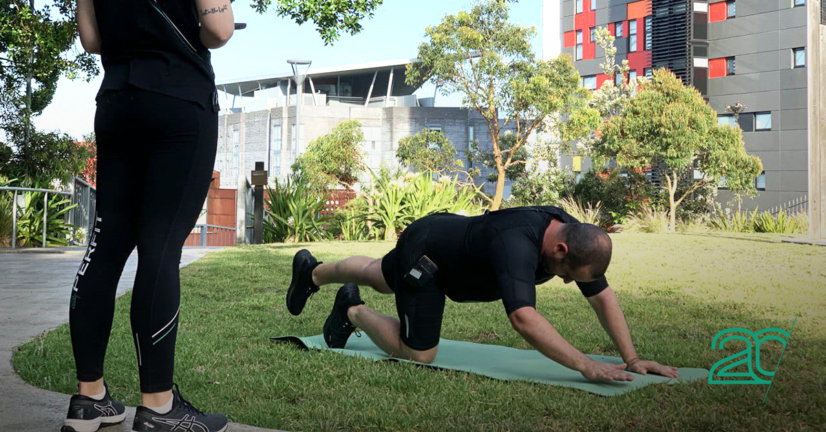 outdoor training session by a 20perfit trainer using an EMC training suit
