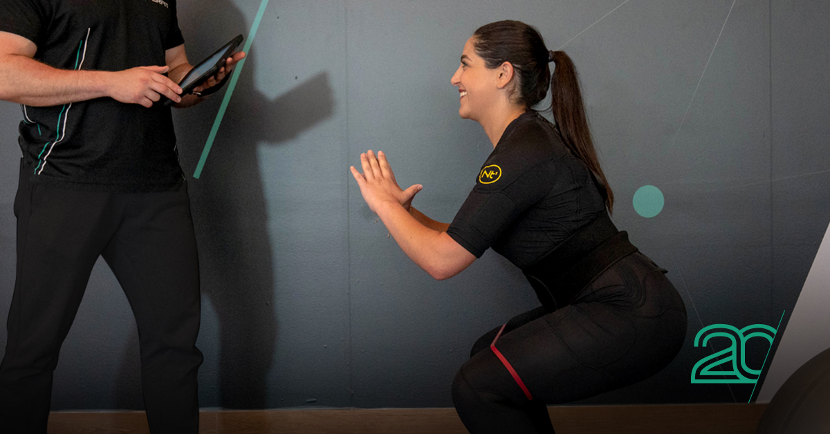 woman training by a certified 20perfit and wearing an EMC training suit 