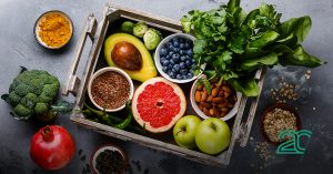 Tray that contains avocado, grapefruits, dried almonds, and many more healthy food